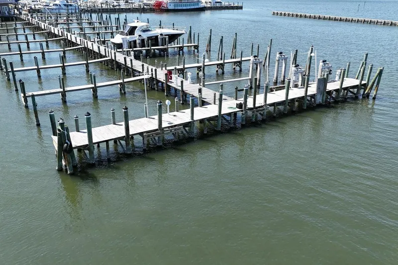 Slide: The Image of Empty marina docks with a single boat, featuring a Custom Paddle Wheel from 1984. - 75