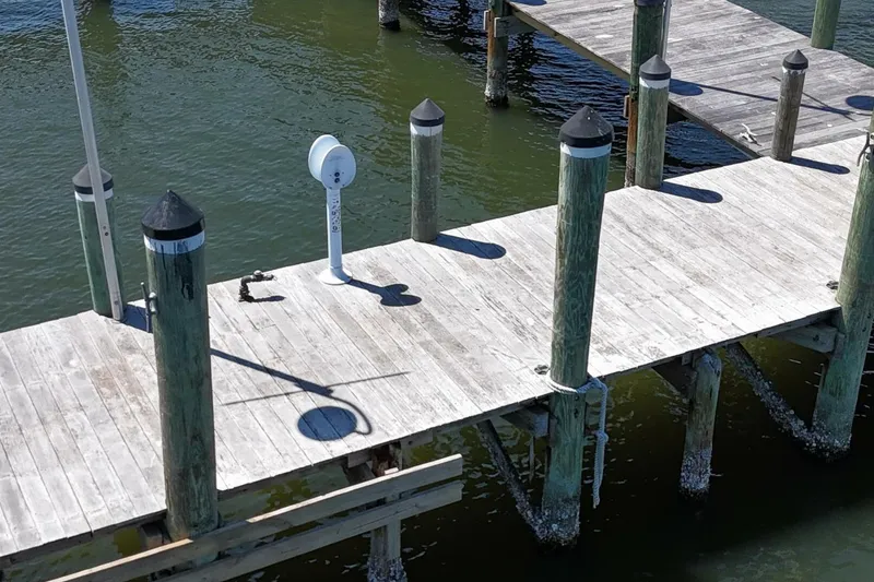 Slide: The Image of Wooden dock with green water, featuring a Custom Paddle Wheel from 1984. - 76