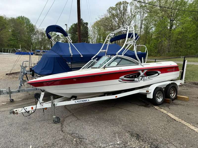 Slide: The Image of 2001 MasterCraft X-Star boat on trailer, parked outdoors. - 1