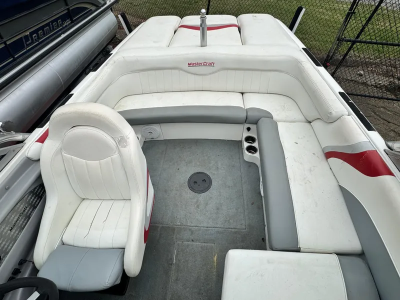Slide: The Image of 2001 MasterCraft X-Star boat interior with white and gray seating, red accents. - 12