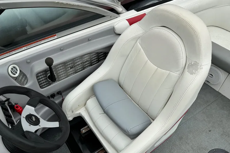 Slide: The Image of 2001 MasterCraft X-Star boat interior with white and gray seating, steering wheel, and controls. - 13