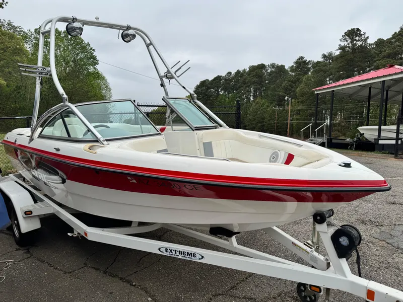 Slide: The Image of 2001 MasterCraft X-Star boat on trailer, red and white design, parked outdoors. - 3