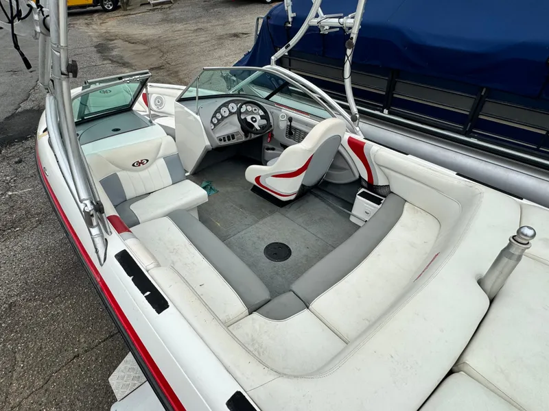 Slide: The Image of 2001 MasterCraft X-Star boat interior with white and red seating, steering wheel, and dashboard. - 6