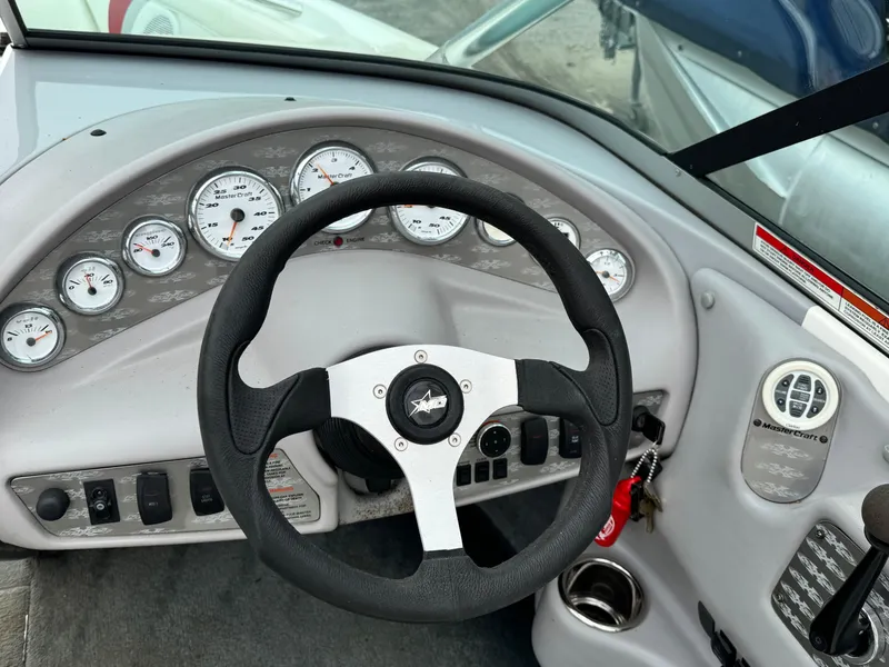 Slide: The Image of 2001 MasterCraft X-Star dashboard with steering wheel and gauges. - 8