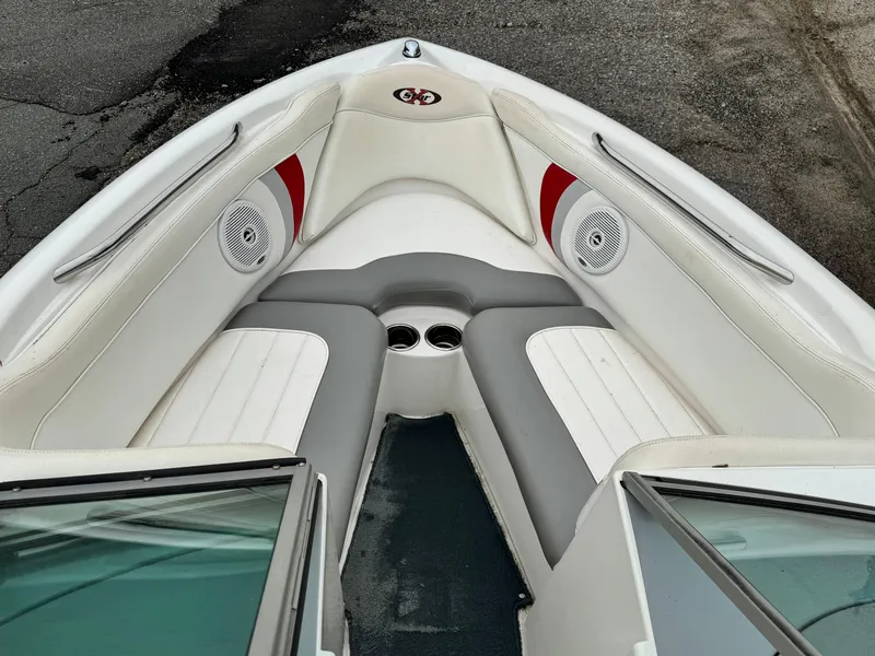 Slide: The Image of 2001 MasterCraft X-Star boat interior with white and gray seating, red accents, and cup holders. - 9