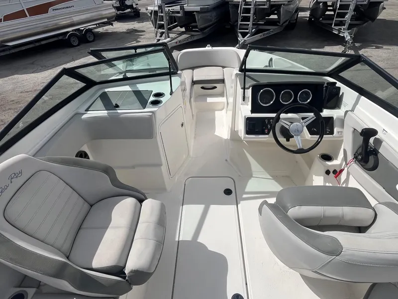 Slide: The Image of 2020 Sea Ray SPX 210 OB boat interior with dual seating and modern dashboard. - 7