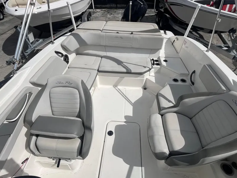 Slide: The Image of 2020 Sea Ray SPX 210 OB boat interior with gray seating and spacious layout. - 8