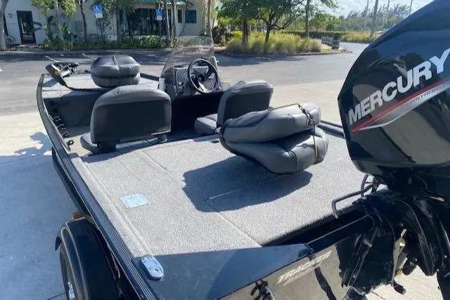 Slide: The Image of 2024 Tracker Bass Tracker Classic XL boat with Mercury engine, featuring spacious seating and deck. - 10