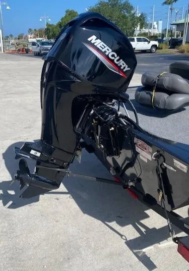 Slide: The Image of 2024 Tracker Bass Tracker Classic XL with Mercury outboard motor in a parking area. - 12