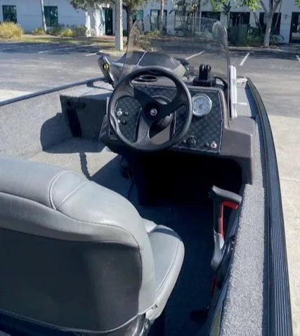 Slide: The Image of 2024 Tracker Bass Tracker Classic XL boat interior with steering wheel and seating. - 13