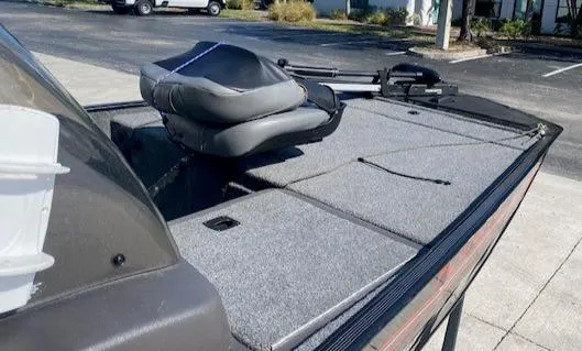 Slide: The Image of 2024 Tracker Bass Tracker Classic XL boat with seating and storage, parked outdoors. - 14