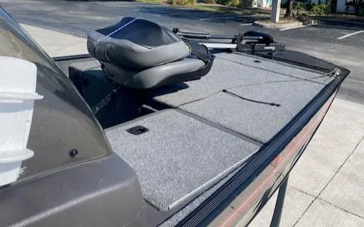 Slide: The Image of 2024 Tracker Bass Tracker Classic XL boat with cushioned seating and spacious deck. - 15