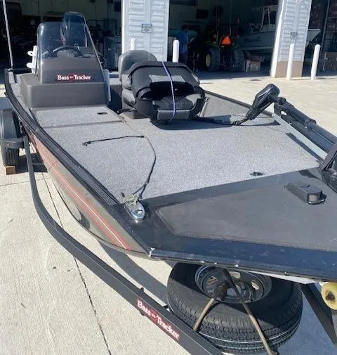 Slide: The Image of 2024 Tracker Bass Tracker Classic XL boat on trailer, parked outside a garage. - 17