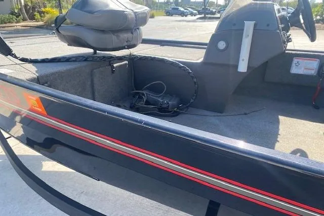 Slide: The Image of 2024 Tracker Bass Tracker Classic XL boat interior with seating and steering console. - 7