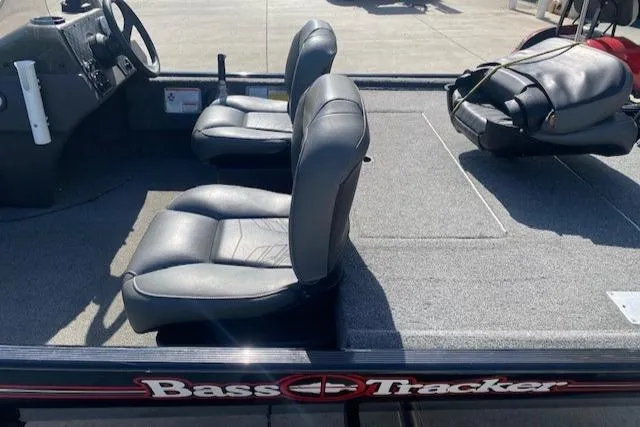 Slide: The Image of 2024 Tracker Bass Tracker Classic XL boat interior with two seats and steering console. - 9