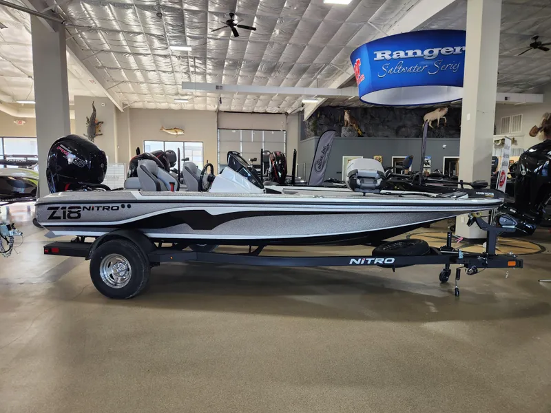 Slide: The Image of 2025 Nitro Z18 boat displayed indoors, showcasing sleek design and modern features. - 0