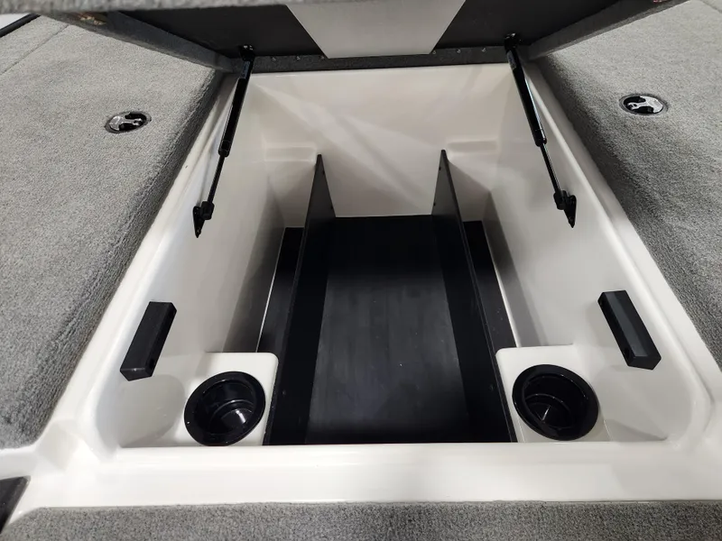 Slide: The Image of 2025 Nitro Z18 boat storage compartment with cup holders and hydraulic lift supports. - 13