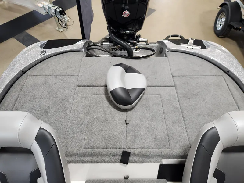 Slide: The Image of 2025 Nitro Z18 boat interior with gray carpet and seating. - 16