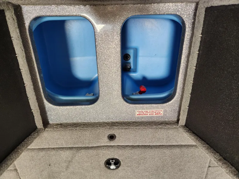 Slide: The Image of Interior storage compartments of a 2025 Nitro Z18 boat, featuring blue plastic bins. - 17