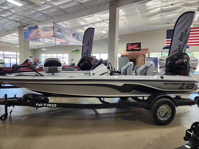 Slide: The Image of 2025 Nitro Z18 boat displayed in showroom with trailer and flags. - 4