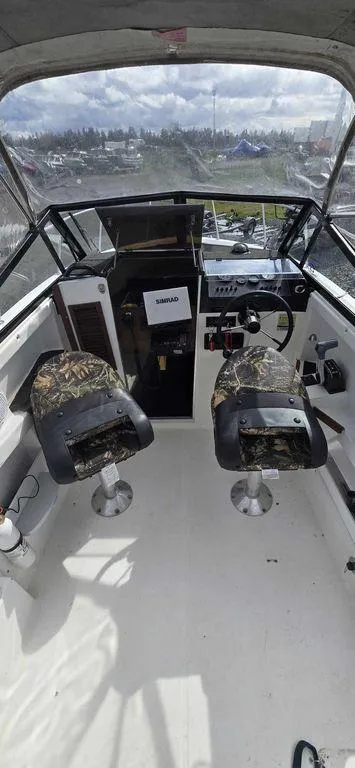 Slide: The Image of Interior view of a 1997 Bayliner 2002 WA boat with camo seats and steering console. - 4