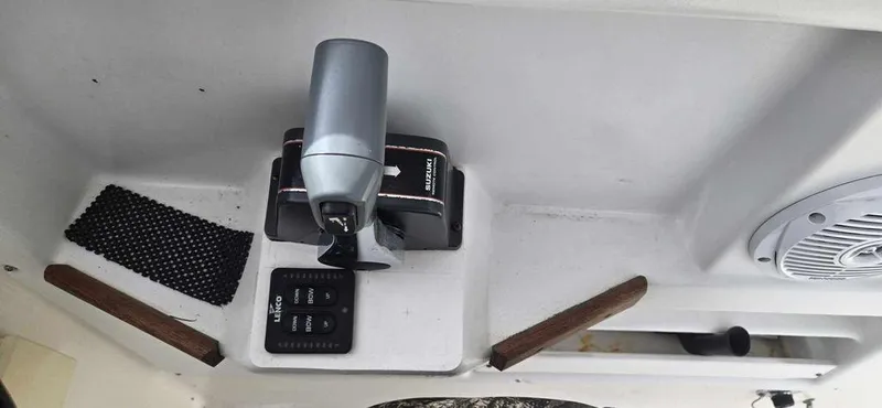 Slide: The Image of Control panel of a 1997 Bayliner 2002 WA boat, featuring throttle and speaker. - 6