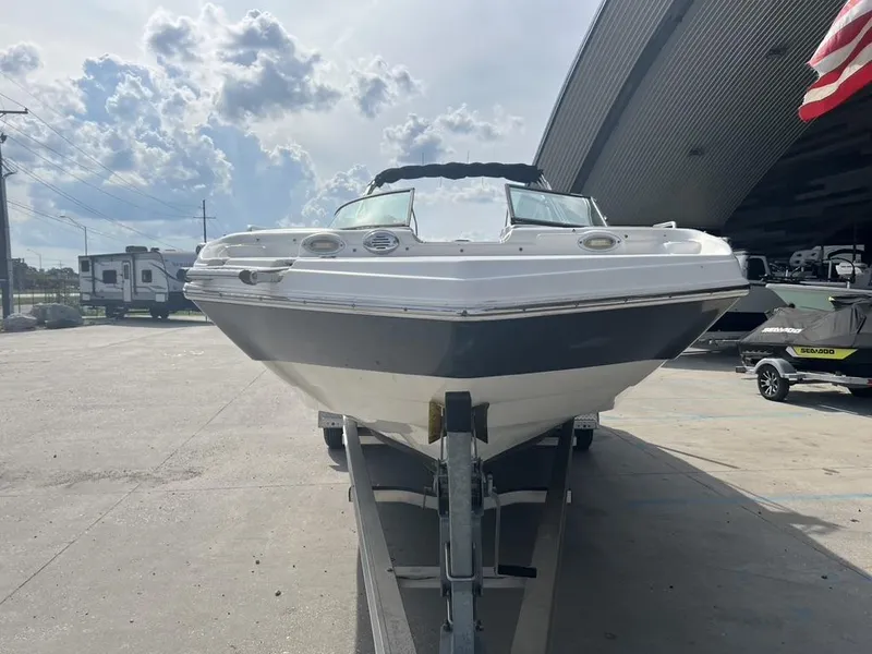 Slide: The Image of 2017 NauticStar 243 DC boat on trailer under cloudy sky. - 4