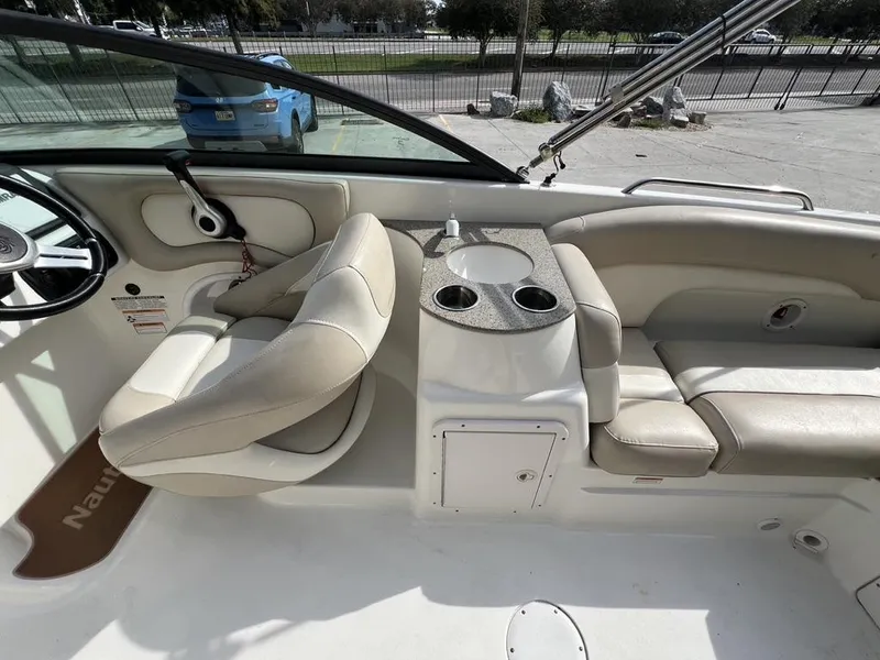 Slide: The Image of 2017 NauticStar 243 DC boat interior with seating and cup holders. - 5