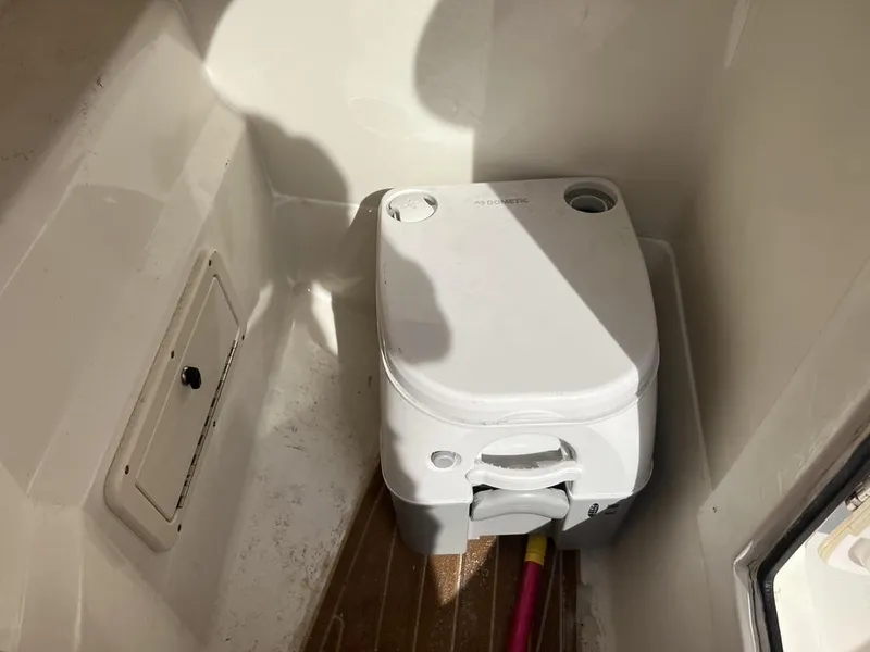 Slide: The Image of Portable toilet inside 2017 NauticStar 243 DC boat cabin. - 8