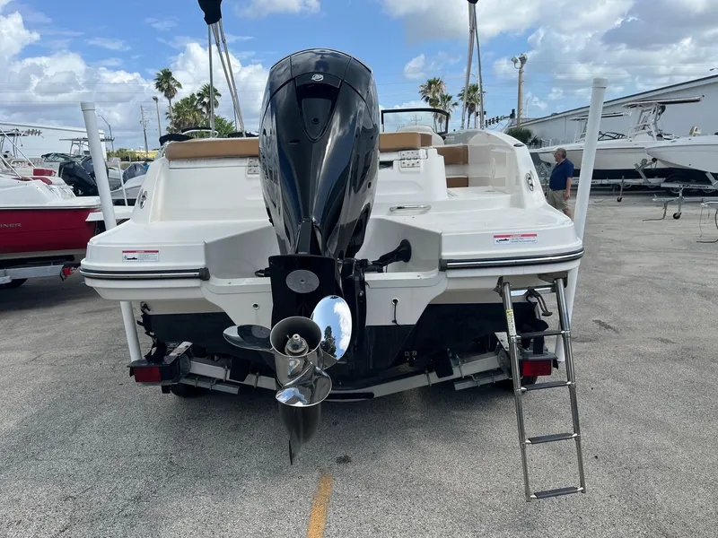 Slide: The Image of 2021 Bayliner VR6 Bowrider OB with outboard motor, parked on a trailer. - 3