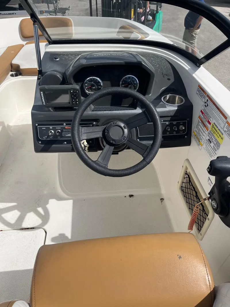 Slide: The Image of 2021 Bayliner VR6 Bowrider OB dashboard with steering wheel and controls. - 5