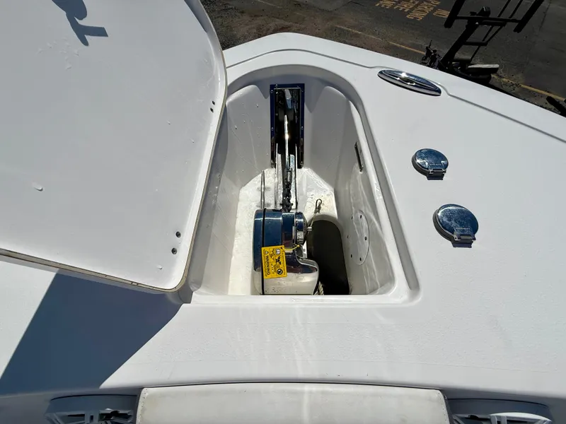 Slide: The Image of 2018 Tidewater 232 CC Adventure boat anchor compartment with open hatch, showcasing storage space. - 17