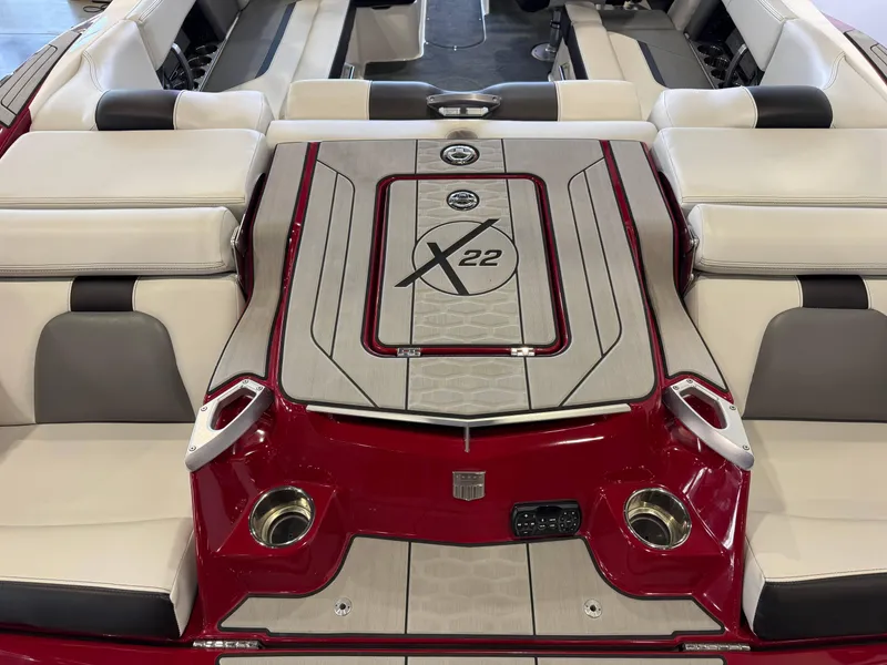 Slide: The Image of 2019 MasterCraft X22 boat interior with red and white seating and deck design. - 10