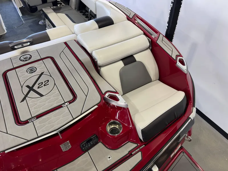 Slide: The Image of 2019 MasterCraft X22 boat interior with red and white seating and deck design. - 11