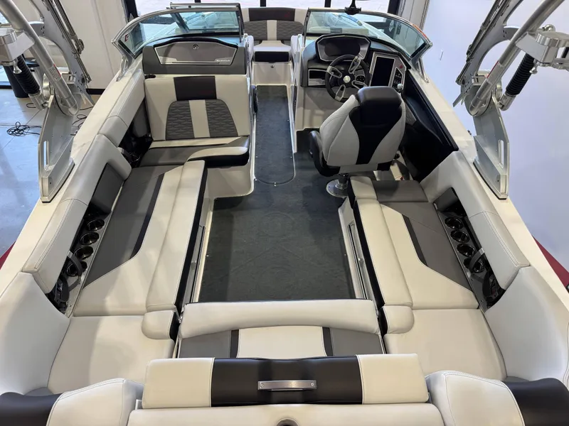 Slide: The Image of 2019 MasterCraft X22 boat interior with sleek seating and modern dashboard design. - 13