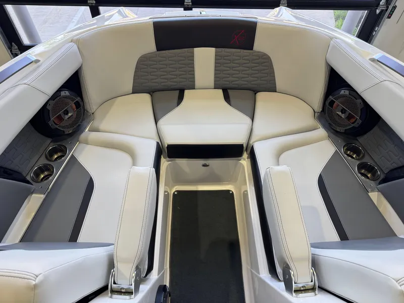 Slide: The Image of 2019 MasterCraft X22 boat interior with luxurious seating and built-in speakers. - 17