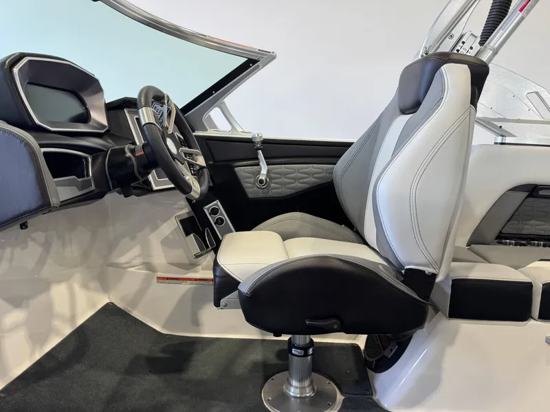 Slide: The Image of 2019 MasterCraft X22 boat interior with sleek steering and modern seating design. - 22