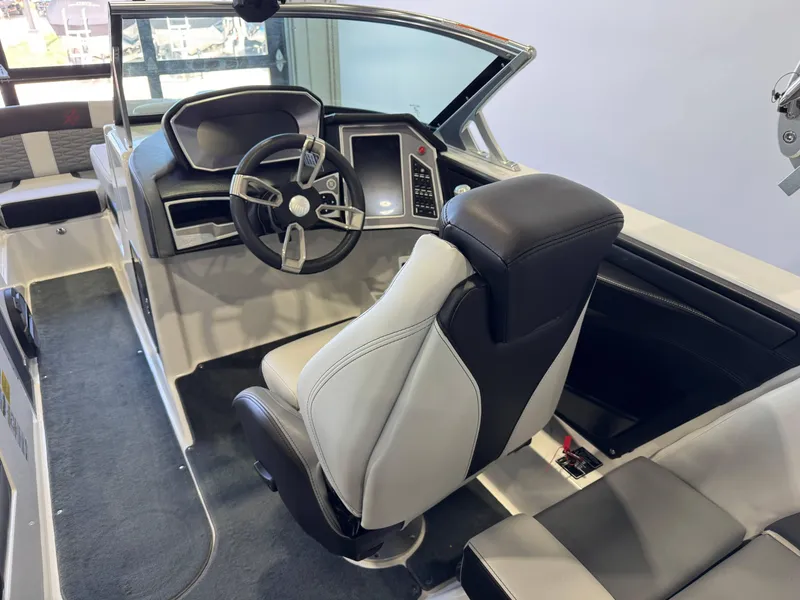 Slide: The Image of 2019 MasterCraft X22 boat interior with modern steering and seating. - 23