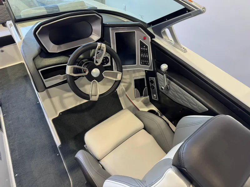 Slide: The Image of 2019 MasterCraft X22 boat interior with modern steering and control panel. - 24