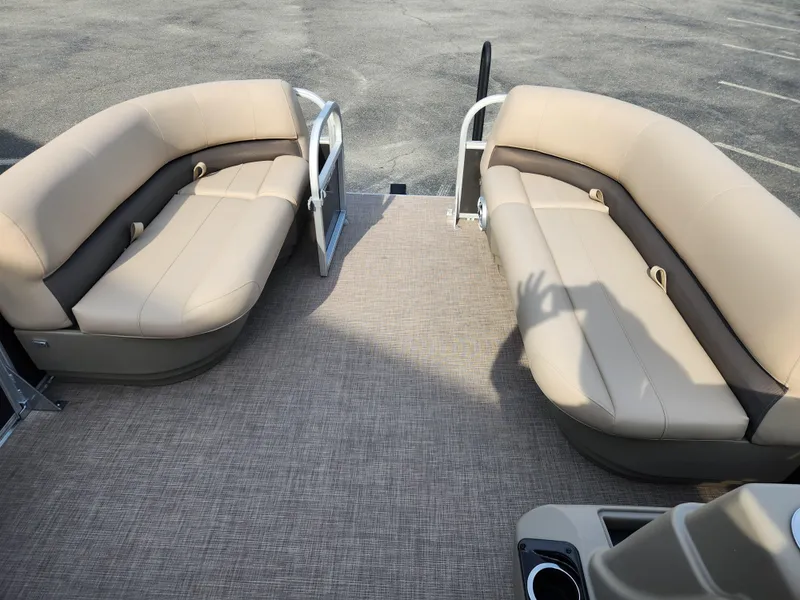 Slide: The Image of 2025 Sun Tracker Party Barge 16 DLX interior with beige seating and carpeted floor. - 11