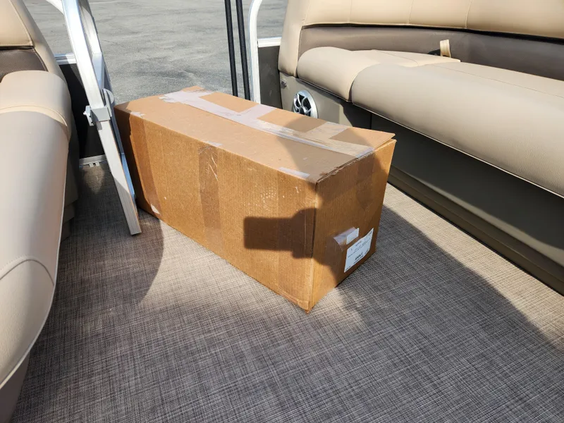 Slide: The Image of Cardboard box on 2025 Sun Tracker Party Barge 16 DLX boat interior. - 12