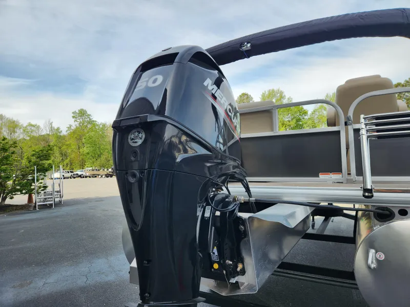 Slide: The Image of 2025 Sun Tracker Party Barge 16 DLX with Mercury outboard motor, docked outdoors. - 3