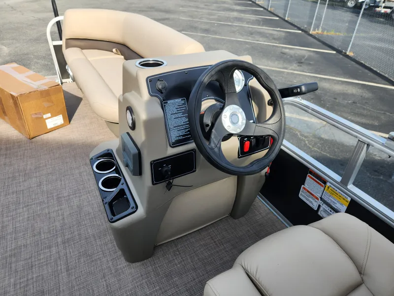 Slide: The Image of 2025 Sun Tracker Party Barge 16 DLX pontoon boat interior with steering console and seating. - 7