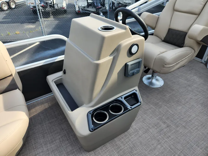 Slide: The Image of 2025 Sun Tracker Party Barge 16 DLX console with cup holders and steering wheel. - 8