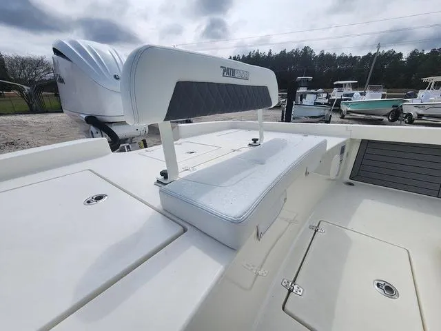 Slide: The Image of 2024 Pathfinder 2600 HPS boat with cushioned seating and storage compartments. - 11
