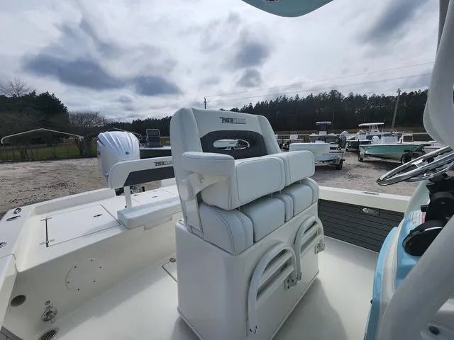 Slide: The Image of 2024 Pathfinder 2600 HPS boat interior with seating and steering wheel. - 12