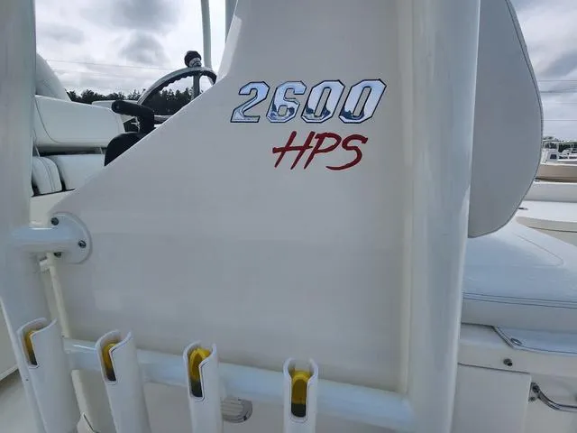 Slide: The Image of 2024 Pathfinder 2600 HPS boat detail with rod holders and logo. - 13