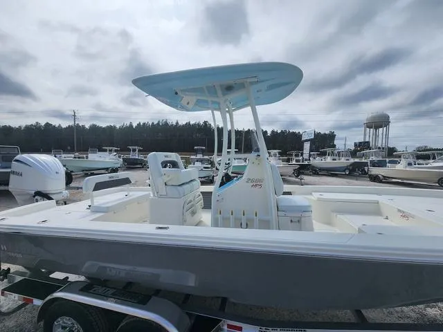 Slide: The Image of 2024 Pathfinder 2600 HPS boat on trailer, displayed outdoors under cloudy sky. - 14