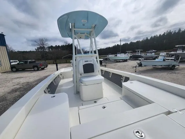 Slide: The Image of 2024 Pathfinder 2600 HPS boat with center console, parked outdoors. - 15