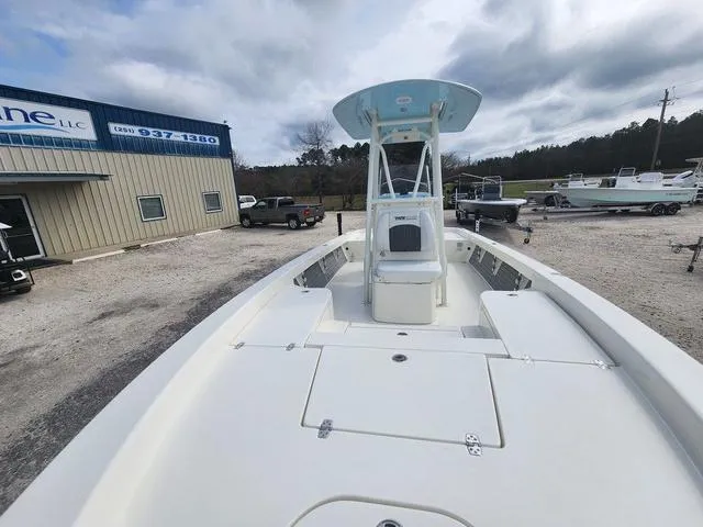 Slide: The Image of 2024 Pathfinder 2600 HPS boat displayed outdoors near a marine dealership. - 16